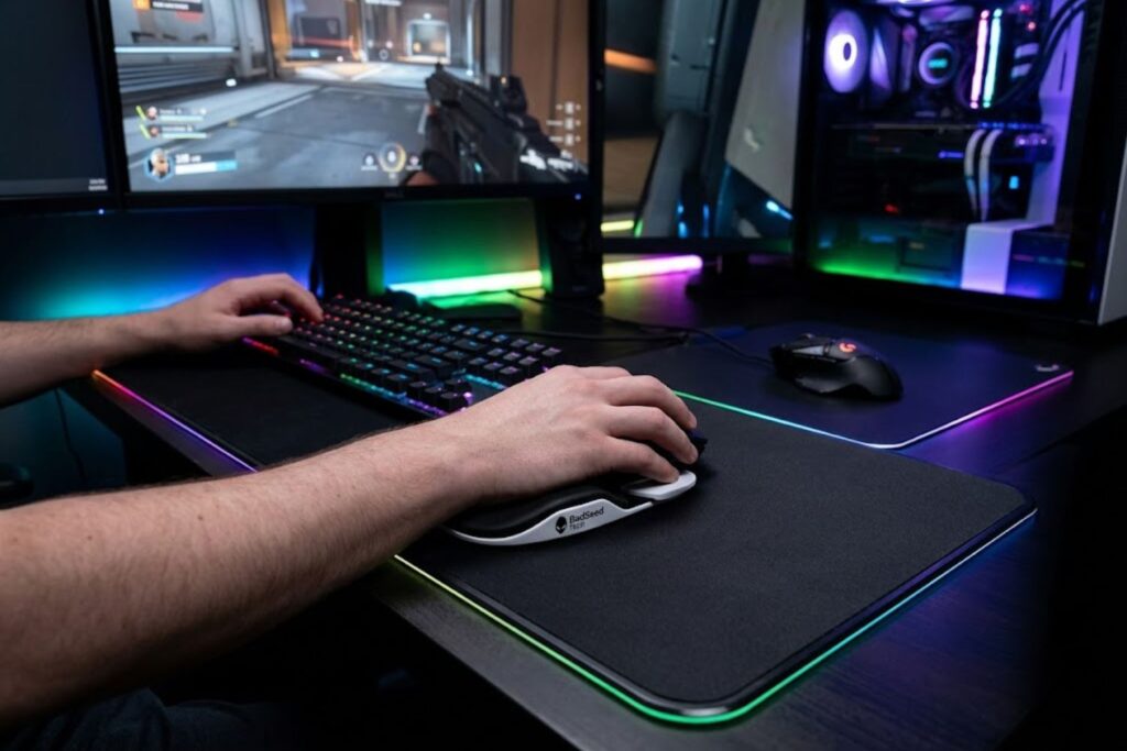 BadSeed Tech Carpio 2.0 gliding wrist rest on dark gaming desk with RGB setup