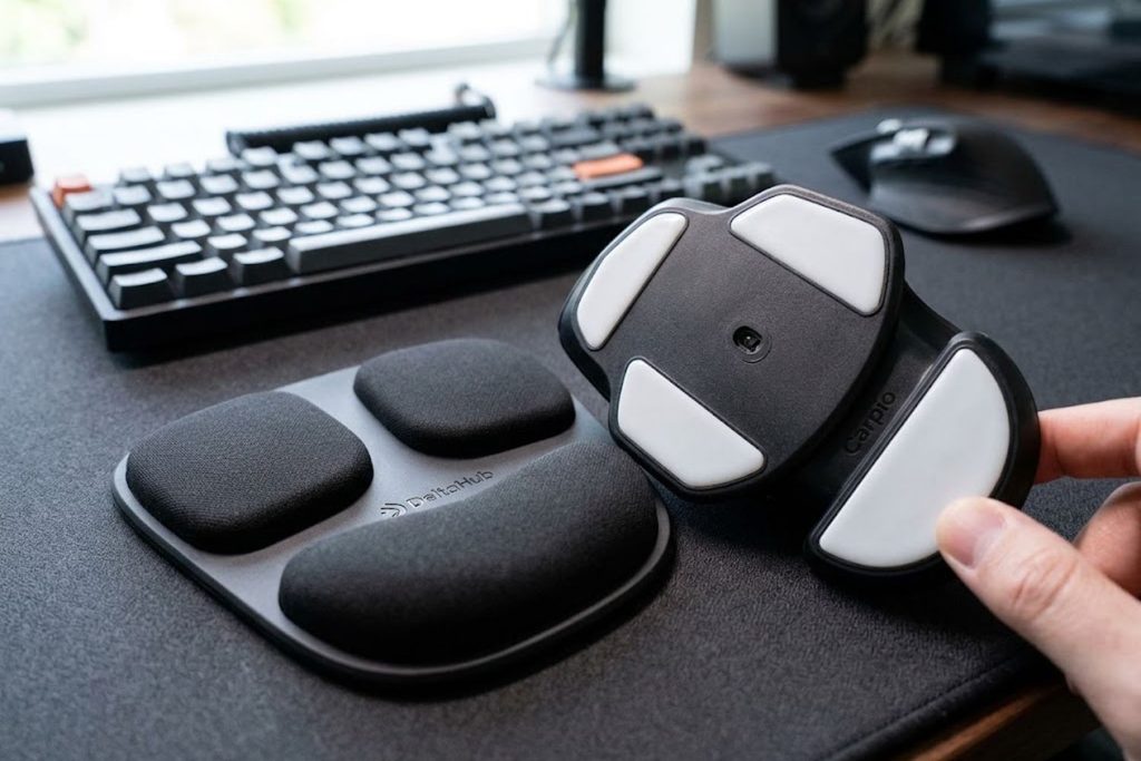 Close-up showing PTFE gliders on underside and silicone top pads of Carpio wrist rest